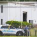 Law enforcement officials stand near the scene of a shooting at Columbia Machine, Inc., in Smithsburg, Md., Thursday, Jan. 9, 2022. (Bill Green/The Frederick News-Post via AP)