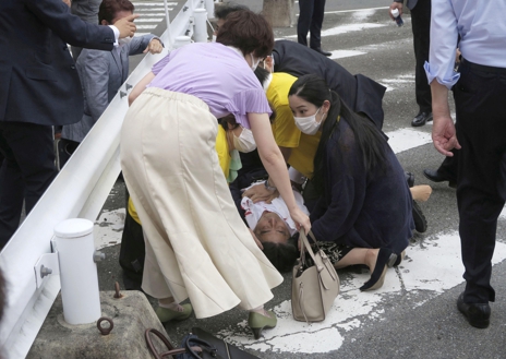 Former Japanese prime minister Shinzo Abe lies on the ground after apparent shooting during an election campaign for the July 10, 2022 Upper House election, in Nara, western Japan July 8, 2022. in this photo taken by Kyodo. Mandatory credit Kyodo via REUTERS ATTENTION EDITORS - THIS IMAGE WAS PROVIDED BY A THIRD PARTY. MANDATORY CREDIT. JAPAN OUT. NO COMMERCIAL OR EDITORIAL SALES IN JAPAN.