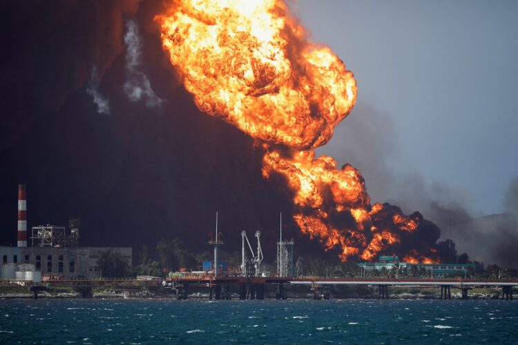 Fire is seen over fuel storage tanks that exploded near Cuba's supertanker port in Matanzas, Cuba, August 8, 2022. REUTERS/Alexandre Meneghini