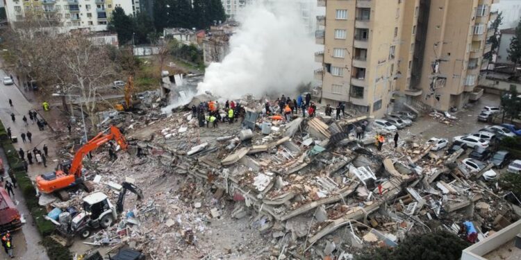 OSMANIYE, TURKIYE - FEBRUARY 06: An aerial view of debris as rescue workers conduct search and rescue operations on a collapsed building after the 7.4 magnitude earthquake hits Osmaniye, Turkiye on February 06, 2023. (Photo by Muzaffer Cagliyaner/Anadolu Agency via Getty Images)
