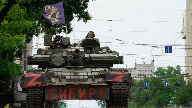 TOPSHOT - Members of Wagner group sit atop of a tank in a street in the city of Rostov-on-Don, on June 24, 2023. President Vladimir Putin on June 24, 2023 said an armed mutiny by Wagner mercenaries was a "stab in the back" and that the group's chief Yevgeny Prigozhin had betrayed Russia, as he vowed to punish the dissidents. Prigozhin said his fighters control key military sites in the southern city of Rostov-on-Don.  (Photo by STRINGER / AFP)